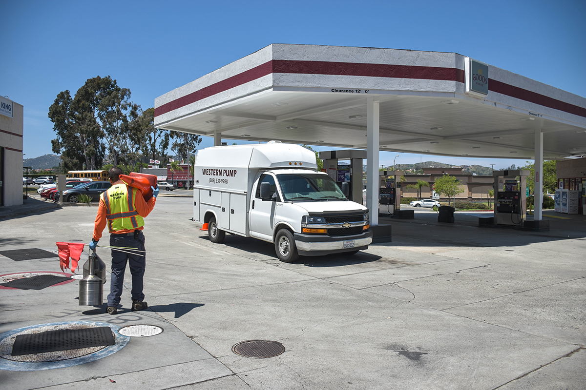 WesternPump service truck and a technician at a gas station in preparation for a fuel cleaning service