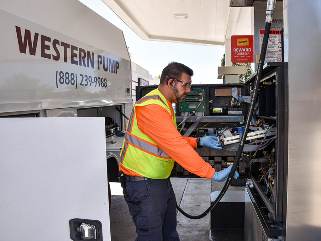 Western Pump service truck and a technician giving maintenance to a fuel pump 