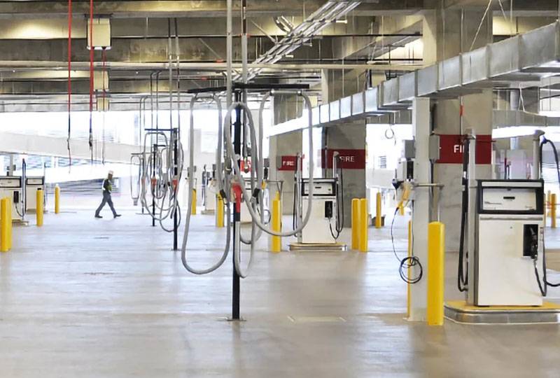 Indoor fueling station with multiple pumps and hoses, designed by Western Pump.